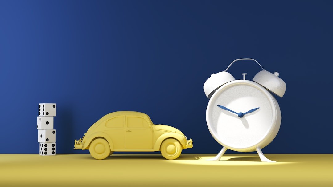 a-toy-car-next-to-a-clock-on-a-table-n4owga4nm-s
